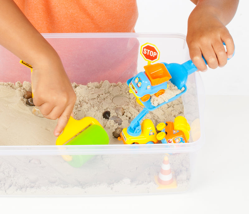 Construction sensory bin with child's hands